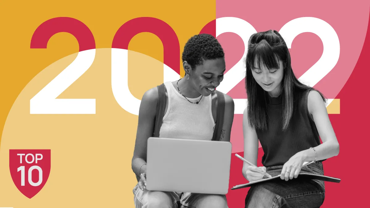 image of two young women, one with an open laptop and one with an open notebook, sitting together against a graphic background of the term "2022"