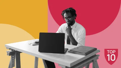 Image of a man sitting at a desk looking at a laptop