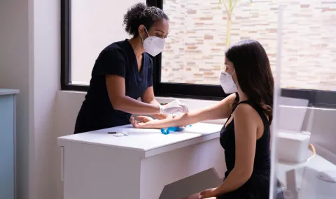 Nurse preparing patient for a vaccination.