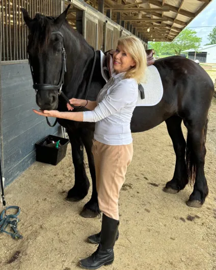 Rebecca feeds her horse, Gigi, a snack.
